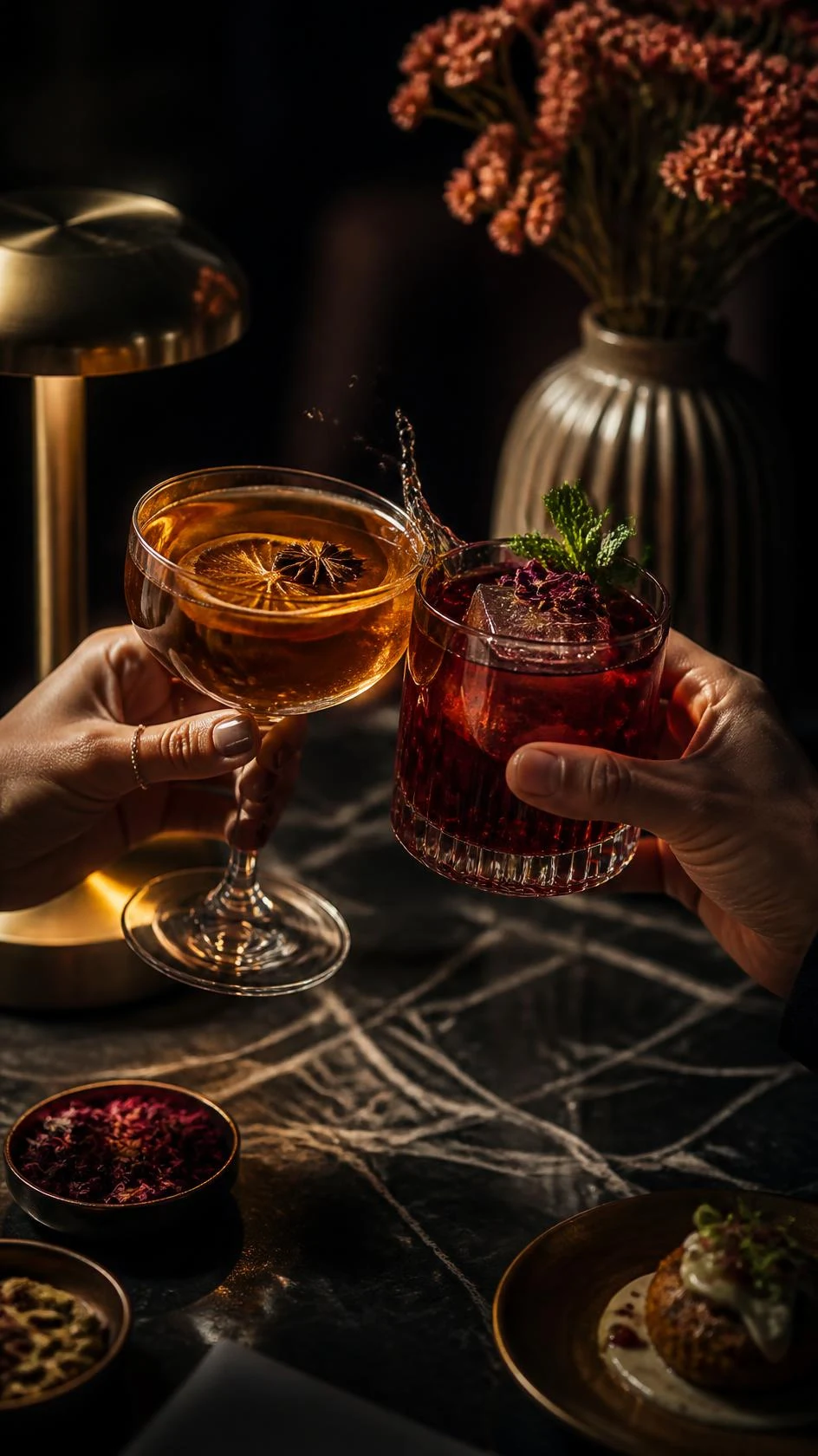 Two people raising their cocktails in a toast